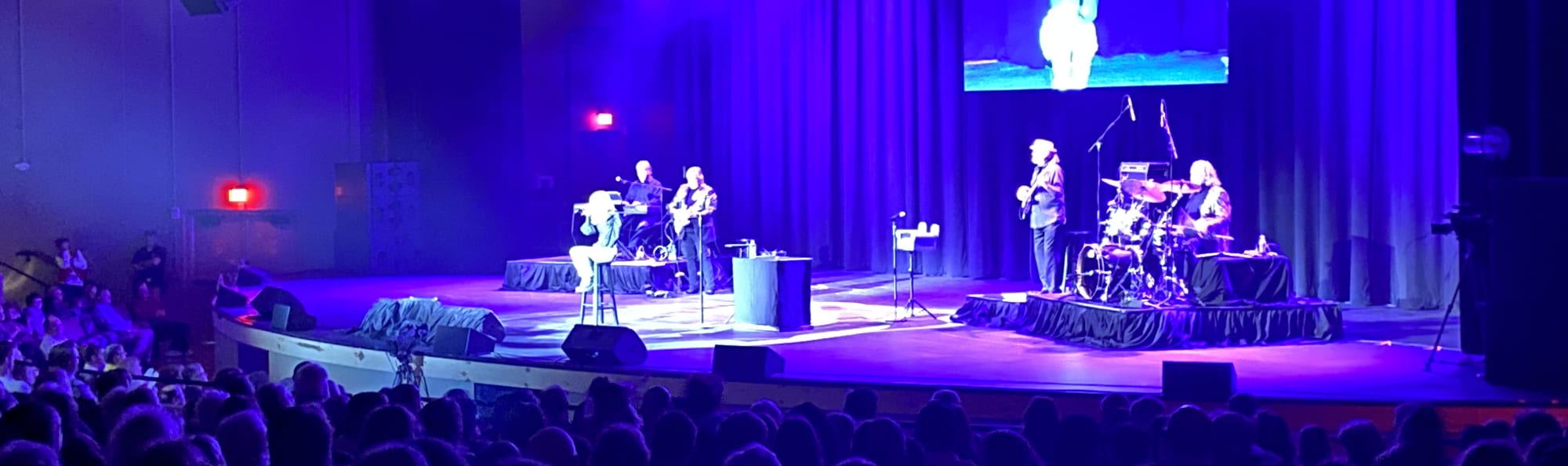 signer on stage in chair washed out by the lights Kansas City